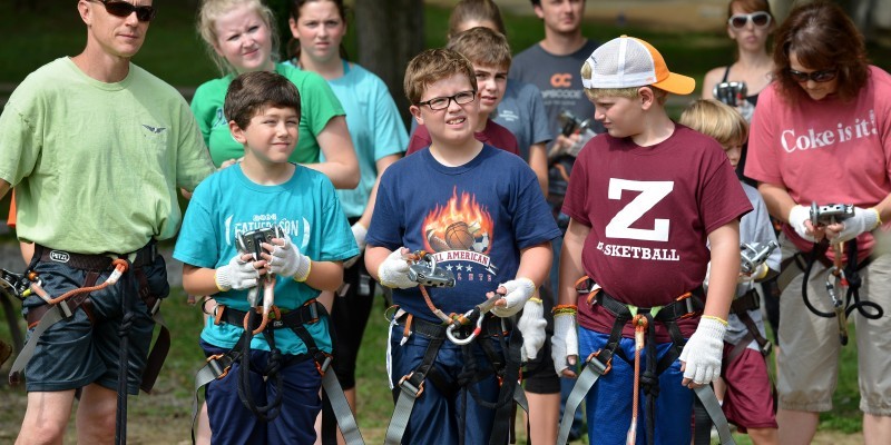 a group of kids wearing harnesses