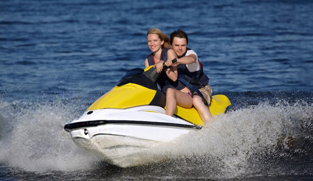 couple-on-jet-ski Couple riding a jet ski on the lake