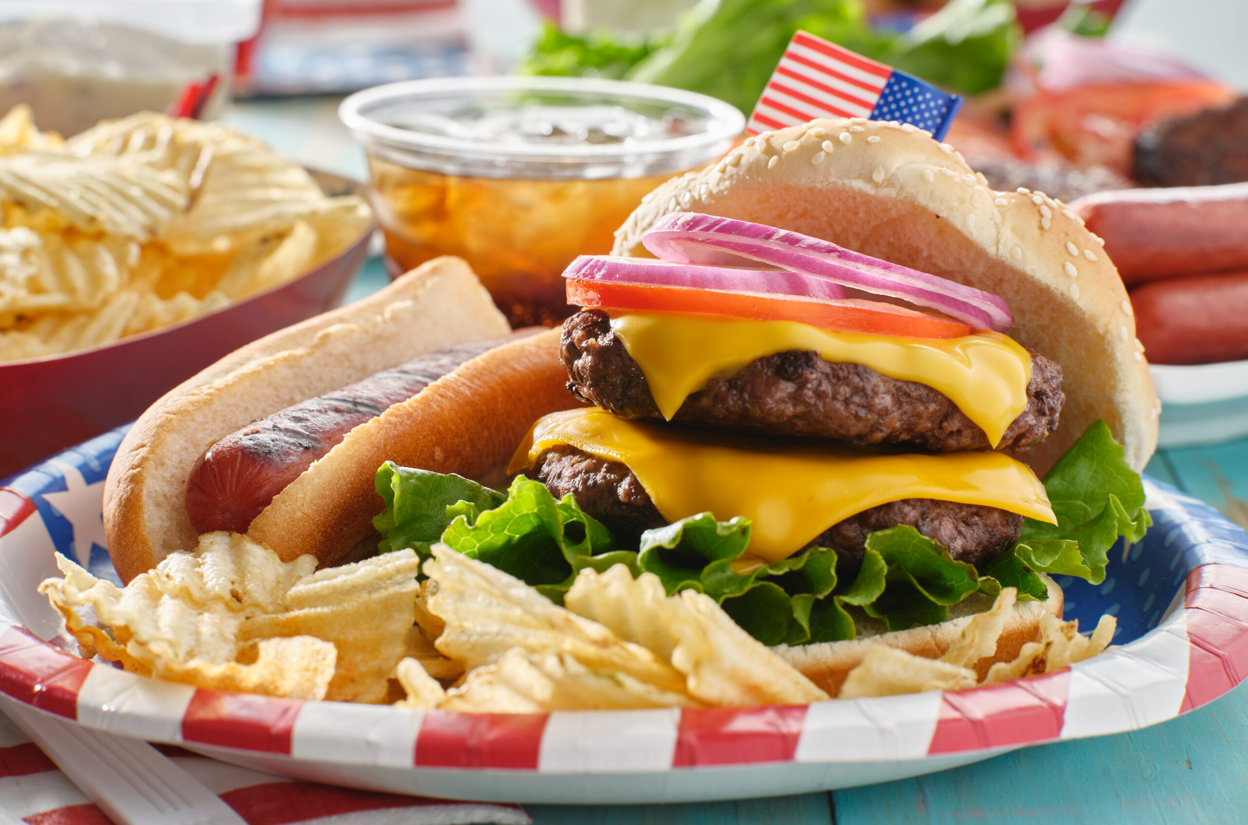 4th of july themed burger and hot dog meal on paper plate