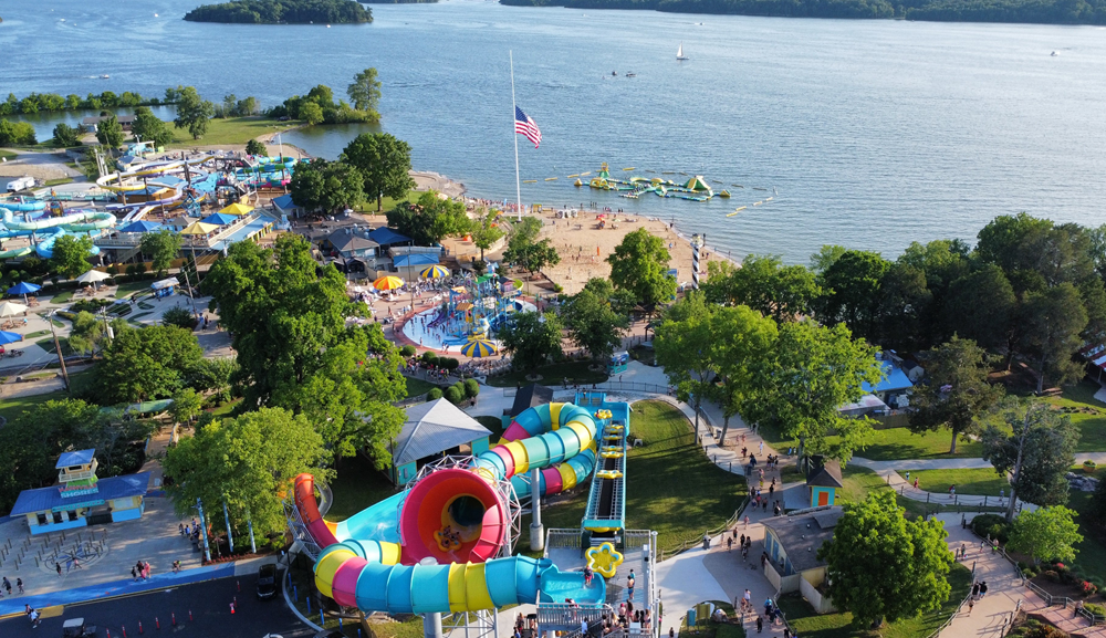 Family celebrating with arms up in wave pool
