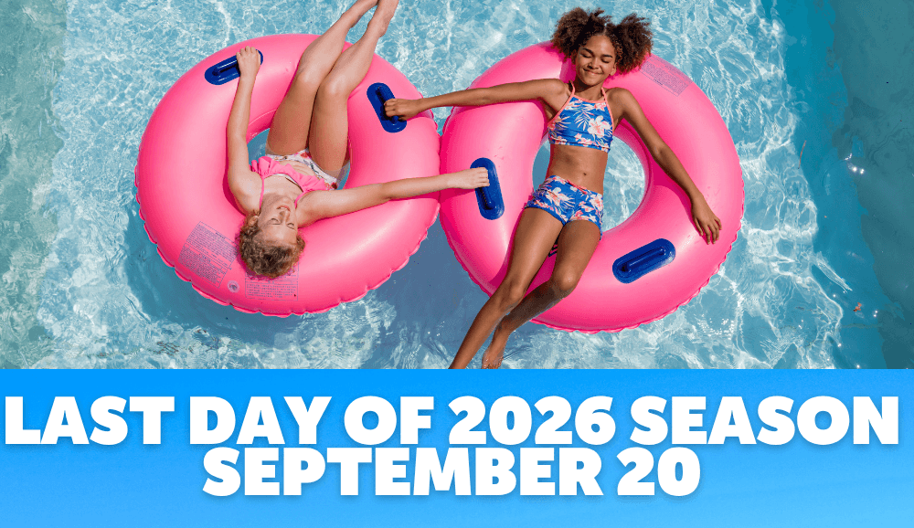 Family celebrating with arms up in wave pool